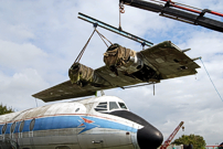 The starboard wing two being lifted over the fuselage.