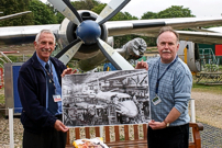 Richard Stanton presented a large photograph of 'Whiskey Fox' on the production line at Weybridge, Surrey, England to John Overhill.