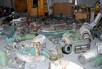 Photo of the hangar floor covered in parts, plumbing & wiring